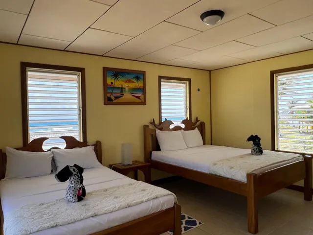 Ocean view guest bedroom — Isla Marisol Resort, Belize
