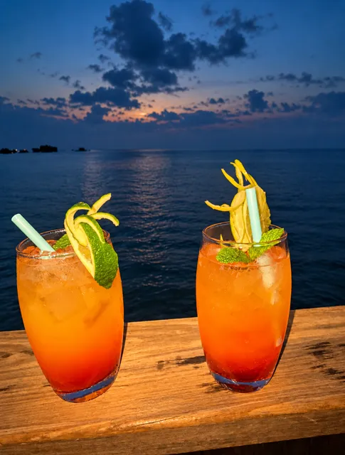Two cocktails beside the sea at sunset